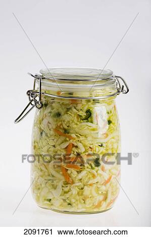 Stock Image - Mason canning jar full of sauerkraut with carrots on a white background; calgary, alberta, canada. Fotosearch