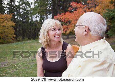 Stock Photograph - Mature married couple on a park bench; edmonton, alberta, canada. Fotosearch