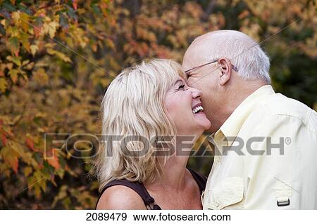 Stock Photo - Mature married couple spending time together in a park in autumn; edmonton, alberta, canada. Fotosearch