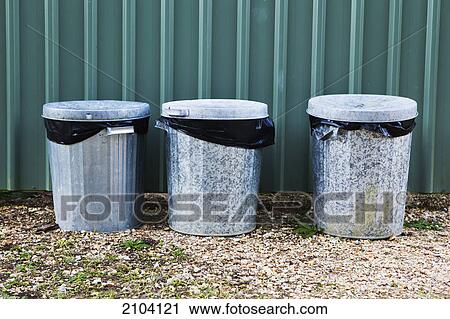 Metal garbage bins in a row against a metal wall; murwillumba new south wales australia View Large Photo Image Stock Image - Metal garbage bins in a row against a metal wall; murwillumba new south wales australia. Fotosearch