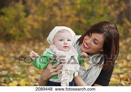 Stock Photo - Mother and baby girl in the park in autumn; edmonton, alberta, canada. Fotosearch