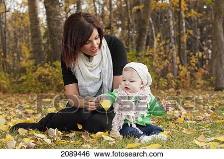 Mother and baby girl in the park in autumn; edmonton, alberta, canada View Large Photo Image Stock Photograph - Mother and baby girl in the park in autumn; edmonton, alberta, canada. Fotosearch