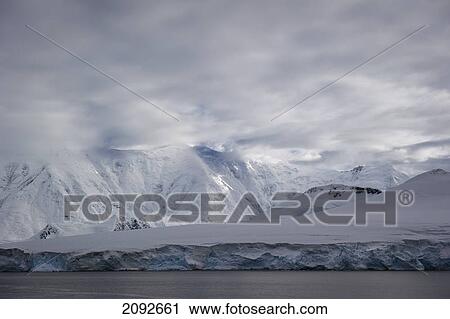 Stock Image - Mountains along the coastline; antarctica. Fotosearch
