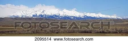 Picture - Mountains with blue sky and pastures near bozeman; montana united states of america. Fotosearch