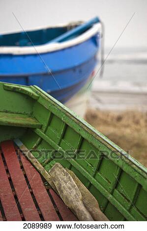 Paddles in a colourful wooden rowboat on the shore; boulmer, northumberland, england View Large Photo Image Stock Photo - Paddles in a colourful wooden rowboat on the shore; boulmer, northumberland, england. Fotosearch