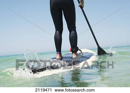 Stock Image - Paddling on a surfboard; tarifa cadiz andalusia spain. Fotosearch