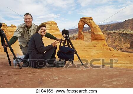 Stock Photography - Photographers at delicate arch; utah united states of america. Fotosearch