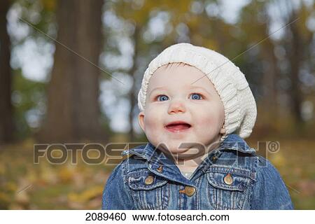 Stock Image - Portrait of a baby girl in a park in autumn; edmonton, alberta, canada. Fotosearch