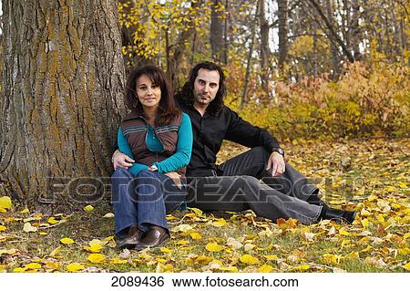 Portrait of a married couple sitting under a tree in autumn; edmonton, alberta, canada View Large Photo Image Stock Photograph - Portrait of a married couple sitting under a tree in autumn; edmonton, alberta, canada. Fotosearch