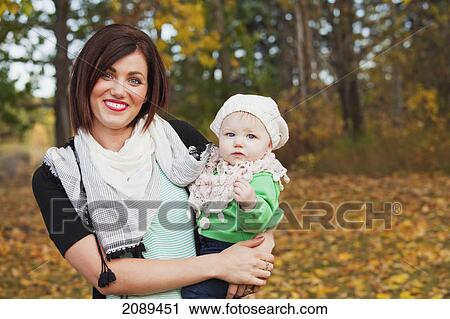Portrait of a mother and her baby daughter in a park in autumn; edmonton, alberta, canada View Large Photo Image Stock Image - Portrait of a mother and her baby daughter in a park in autumn; edmonton, alberta, canada. Fotosearch