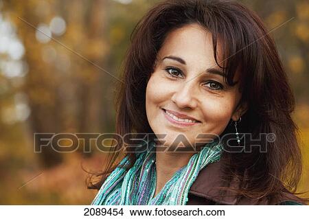 Picture - Portrait of a woman in a park in autumn; edmonton, alberta, canada. Fotosearch