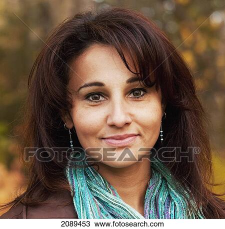 Stock Image - Portrait of a woman in a park in autumn; edmonton, alberta, canada. Fotosearch