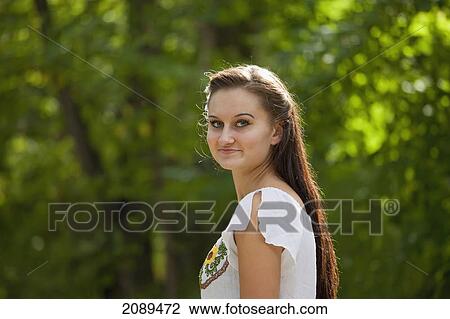Portrait of a young woman in a park; edmonton, alberta, canada View Large Photo Image Stock Image - Portrait of a young woman in a park; edmonton, alberta, canada. Fotosearch