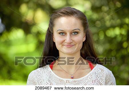 Portrait of a young woman in the park; edmonton, alberta, canada View Large Photo Image Stock Photo - Portrait of a young woman in the park; edmonton, alberta, canada. Fotosearch