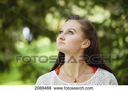 Portrait of a young woman in the park; edmonton, alberta, canada View Large Photo Image Stock Photo - Portrait of a young woman in the park; edmonton, alberta, canada. Fotosearch