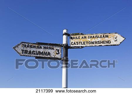 Road sign in english and gaelic pointing to castletownshend and tragumna; county cork ireland View Large Photo Image Stock Photo - Road sign in english and gaelic pointing to castletownshend and tragumna; county cork ireland. Fotosearch