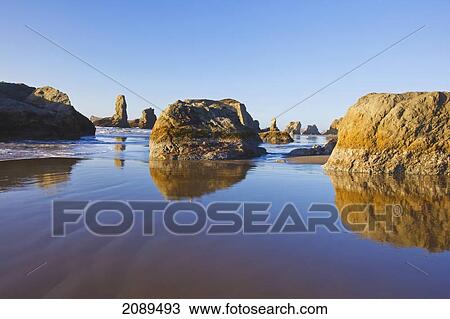Stock Image - Rock formations at low tide on bandon beach; oregon, united states of america. Fotosearch