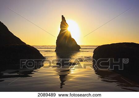 Rock formations at low tide on bandon beach at sunset; oregon, united states of america View Large Photo Image Stock Photo - Rock formations at low tide on bandon beach at sunset; oregon, united states of america. Fotosearch