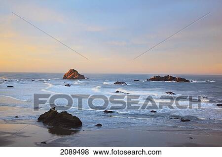 Stock Photo - Rock formations at low tide on bandon beach at sunset; oregon, united states of america. Fotosearch