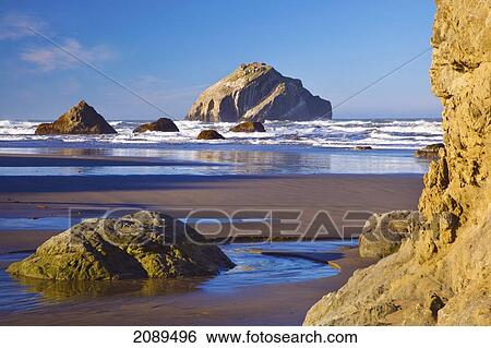 Stock Photograph - Rock formations at low tide on bandon beach; oregon, united states of america. Fotosearch