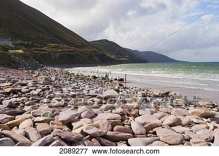 Rocks on a beach and view of the coastline; ireland View Large Photo Image Stock Photo - Rocks on a beach and view of the coastline; ireland. Fotosearch