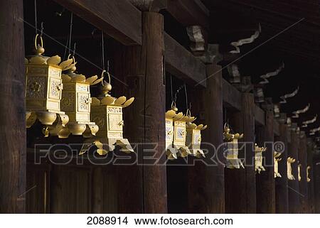 Row of golden japanese metal lanterns hanging in a temple; kyoto, japan View Large Photo Image Picture - Row of golden japanese metal lanterns hanging in a temple; kyoto, japan. Fotosearch