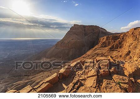 Rugged terrain and sunbeams at sunrise; masada israel View Large Photo Image Stock Photo - Rugged terrain and sunbeams at sunrise; masada israel. Fotosearch