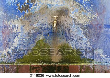 Stock Photograph - Running tap in public fountain; chefchaouen morocco. Fotosearch