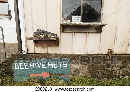 Sign for bee hive huts leaning against a building with a window to pay admission; ireland View Large Photo Image Stock Photo - Sign for bee hive huts leaning against a building with a window to pay admission; ireland. Fotosearch