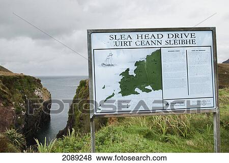 Stock Photo - Sign for slea head drive at the water's edge; ireland. Fotosearch