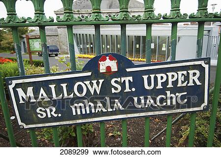 Stock Photo - Sign posted on a fence for mallow st. upper; ireland. Fotosearch