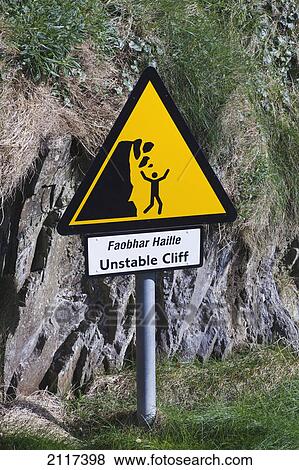 Stock Photo - Sign warning of dangerous cliff edge sandy cove west cork; county cork ireland. Fotosearch