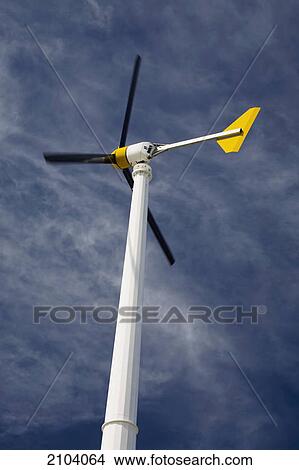 Small windmill against a blue sky and clouds; alberta canada View Large Photo Image Picture - Small windmill against a blue sky and clouds; alberta canada. Fotosearch