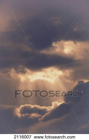 Sun rays bursting through storm clouds; spain View Large Photo Image Stock Photo - Sun rays bursting through storm clouds; spain. Fotosearch