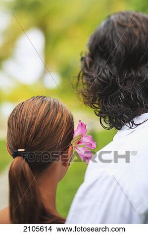 The back of the heads of a man and woman the woman having a flower in her hair bora bora nui resort and spa; bora bora island society islands french polynesia south pacific View Large Photo Image Picture - The back of the heads of a man and woman the woman having a flower in her hair bora bora nui resort and spa; bora bora island society islands french polynesia south pacific. Fotosearch