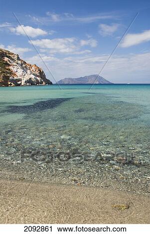 Stock Image - The beach and coastline of the bay; plathiena, island of milos, greece. Fotosearch