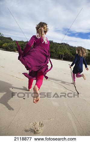 Two girls running on a beach; gold coast queensland australia View Large Photo Image Stock Photo - Two girls running on a beach; gold coast queensland australia. Fotosearch