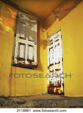 Stock Image - Two rusted doors on different levels; cane garden bay tortula british virgin islands. Fotosearch