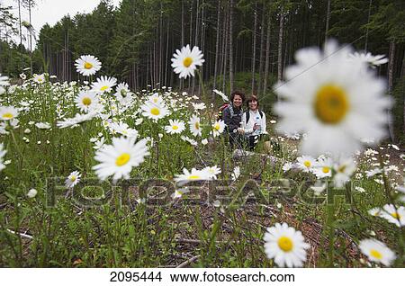Two women hiking in the cowichan valley on vancouver island; british columbia canada View Large Photo Image Picture - Two women hiking in the cowichan valley on vancouver island; british columbia canada. Fotosearch