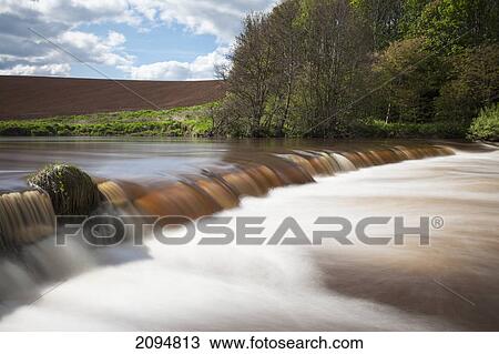 Water cascading over a ledge in a river; northumberland, england View Large Photo Image Stock Image - Water cascading over a ledge in a river; northumberland, england. Fotosearch