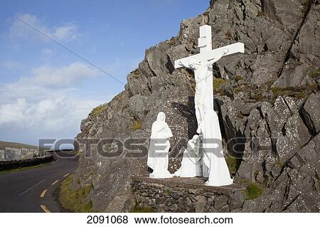 Stock Photo - White religious figures standing on a rock beside the road at slea head, near dunquin on the dingle peninsula; county kerry, ireland. Fotosearch