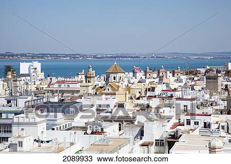 Stock Image - Whitewashed buildings in a town along the coast; cadiz, andalusia, spain. Fotosearch
