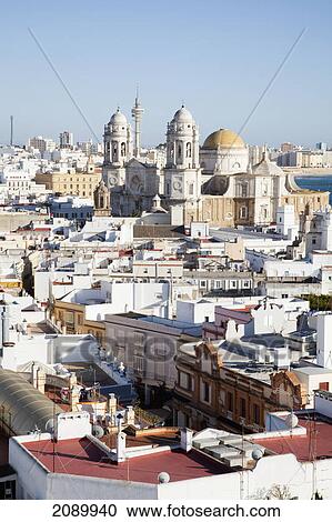 Stock Image - Whitewashed town along the coast and cadiz cathedral; cadiz, andalusia, spain. Fotosearch