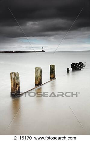 Wooden posts in the tranquil water; berwick northumberland england View Large Photo Image Stock Image - Wooden posts in the tranquil water; berwick northumberland england. Fotosearch