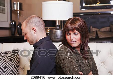 Young couple back to back in a fight; edmonton, alberta, canada View Large Photo Image Stock Photograph - Young couple back to back in a fight; edmonton, alberta, canada. Fotosearch