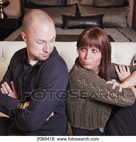 Young couple back to back pretending to fight; edmonton, alberta, canada View Large Photo Image Stock Photo - Young couple back to back pretending to fight; edmonton, alberta, canada. Fotosearch