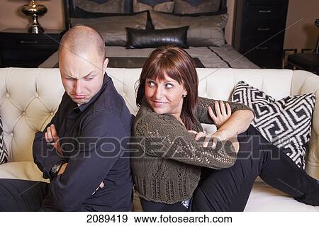 Young couple back to back pretending to fight; edmonton, alberta, canada View Large Photo Image Stock Photo - Young couple back to back pretending to fight; edmonton, alberta, canada. Fotosearch