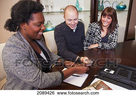 Young couple shopping for furniture with interior design consultant; edmonton, alberta, canada View Large Photo Image Stock Photograph - Young couple shopping for furniture with interior design consultant; edmonton, alberta, canada. Fotosearch