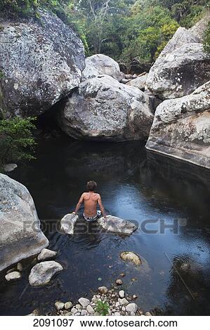 Young man wading in guadalmesi river in the los alcornocales natural park; tarifa, cadiz, andalusia, spain View Large Photo Image Stock Photo - Young man wading in guadalmesi river in the los alcornocales natural park; tarifa, cadiz, andalusia, spain. Fotosearch
