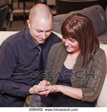 Young married couple admiring wedding ring; edmonton, alberta, canada View Large Photo Image Stock Image - Young married couple admiring wedding ring; edmonton, alberta, canada. Fotosearch